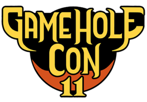 Game Hole Con 11 logo. The words are in fancy gold text outlined in black. Sits on an orange circle.